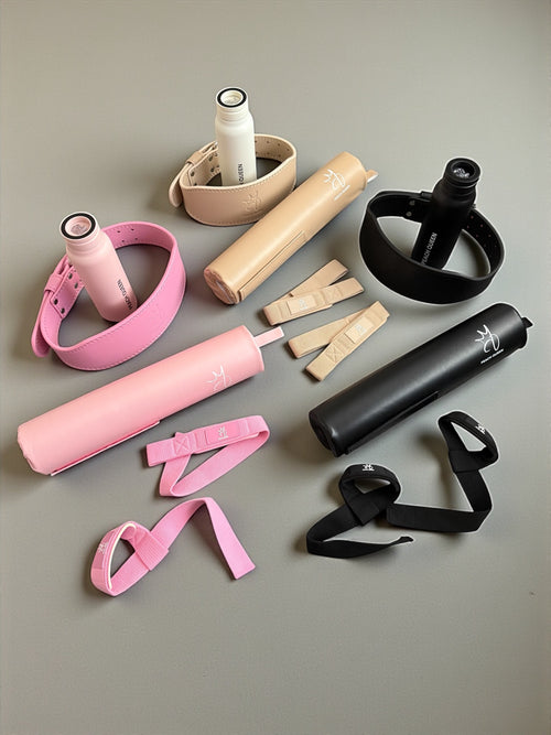 Collection of exercise equipment including resistance bands and straps on a gray background