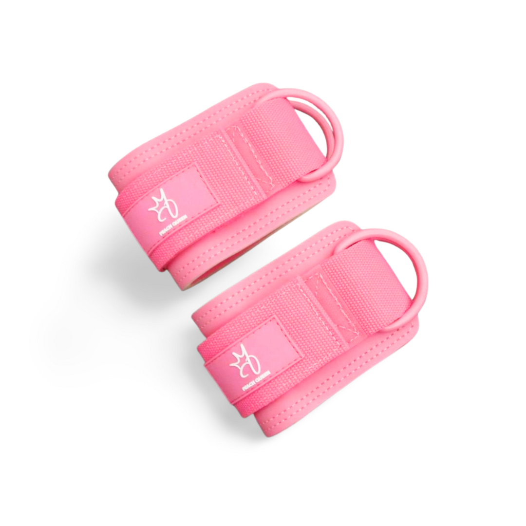 Two pink anklestraps with a brand logo on a white background