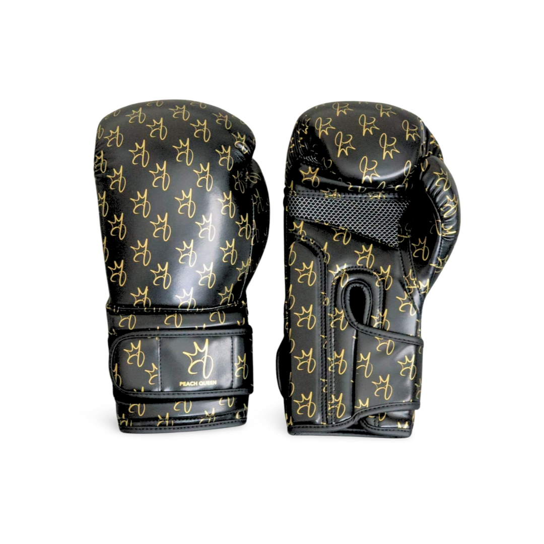 Black boxing gloves with gold patterns on a white background